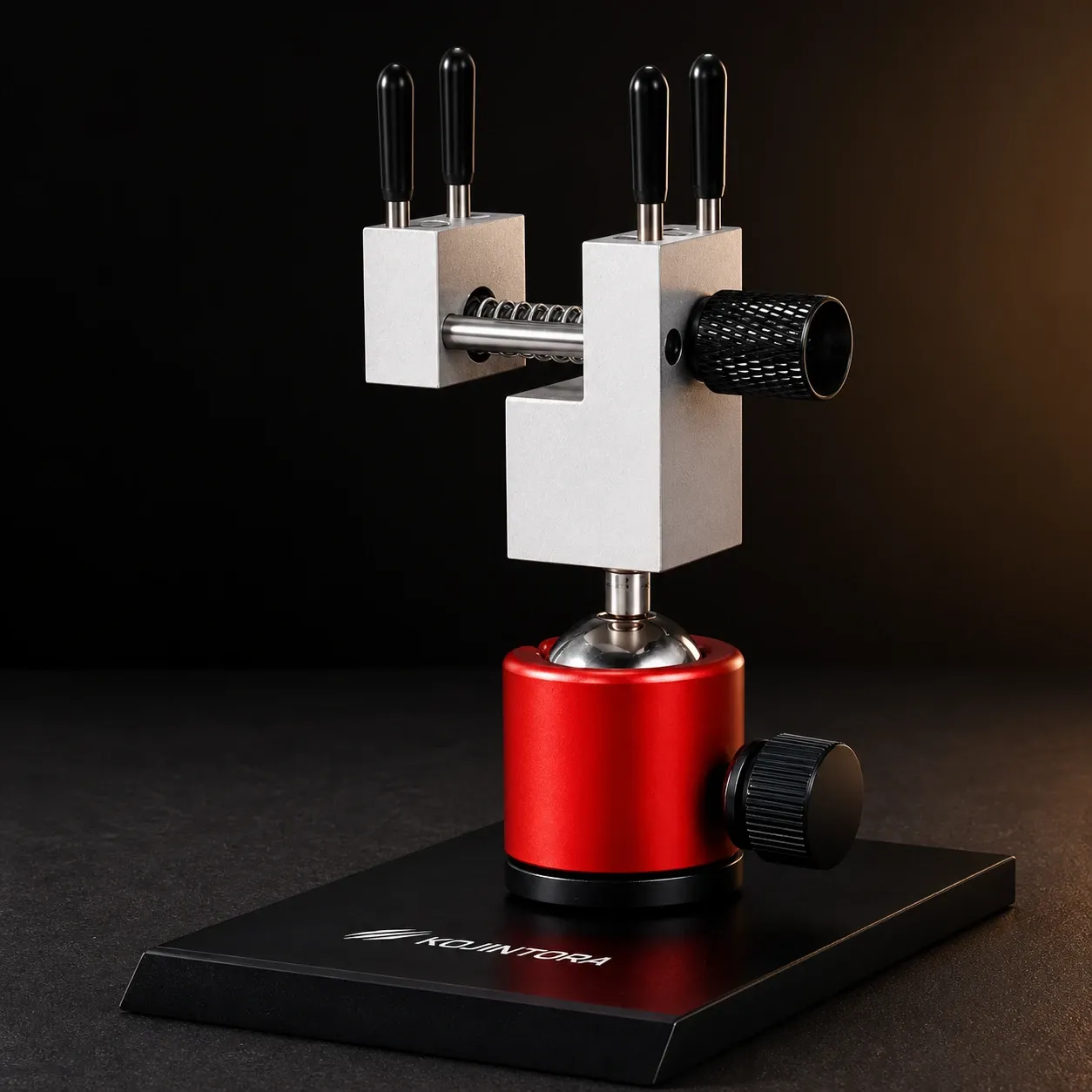 A precision vise with black clamping pins and a red rotating base shown on a dark studio background.